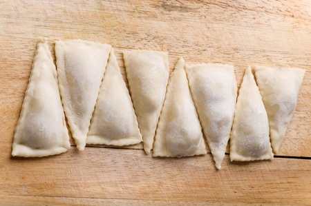 homemade meat dumplings on a cutting boardの写真素材
