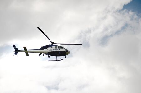Police helicopter in the background of the cloudy sky