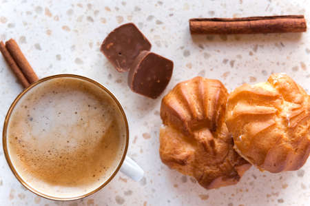 cup of coffee with chocolate and canella, eclair