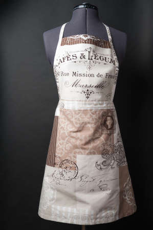 Female kitchen apron on a mannequin on a black backgroundの写真素材