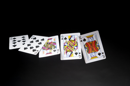 flying playing cards on a dark background-Royal Flush on black