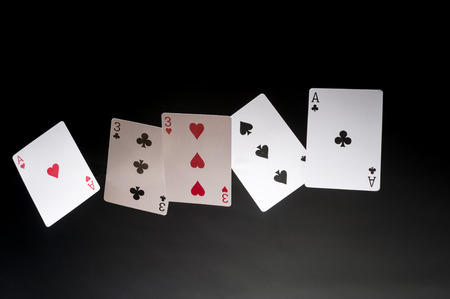 flying playing cards on a dark background - Full Houseの写真素材