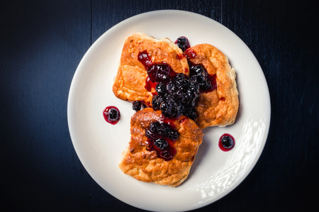 cottage cheese cake with black chokeberry jam on dark