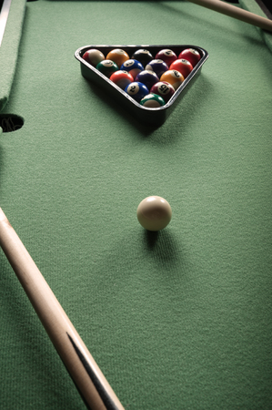 billiard table with green material and billiard balls