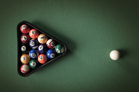 billiard table with green material and billiard balls