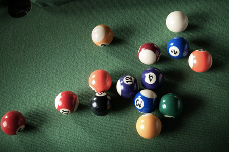 billiard table with green material and billiard balls