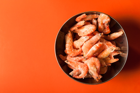shrimp on a metal bowl on red backgroundの写真素材