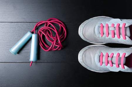 flat lay sports accessories sneakers with jump rope on blackの写真素材