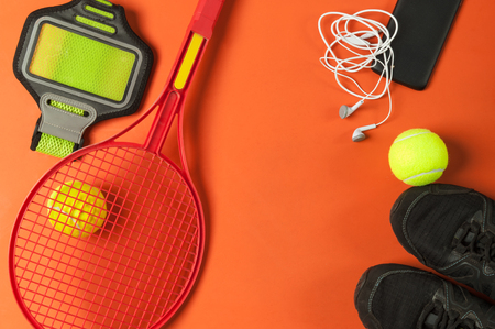 tennis set with tennis racket and smartphone on red backgroundの写真素材