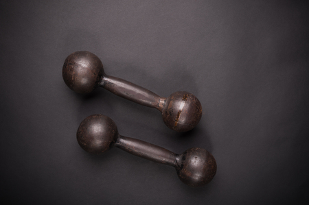 dumbbell with typesetting discs weighting on dark backgroundの写真素材