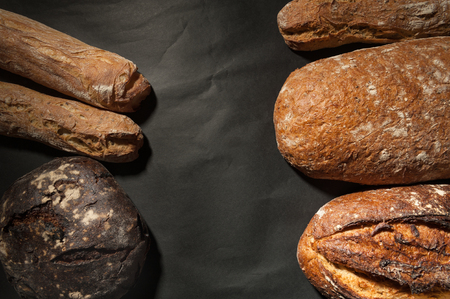 grain bread and fig bread with prunes on dark backgroundの写真素材