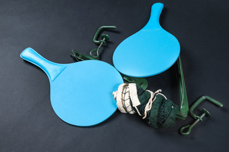 table tennis racket and net on dark background