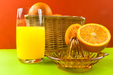 manual juicer with oranges on colored backgroundの写真素材