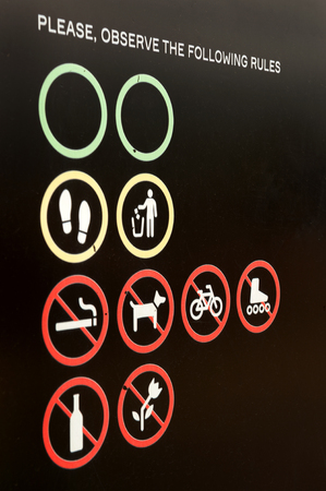 sign observe the following rules on dark backgroundの写真素材