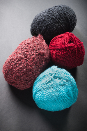 different color wool balls on dark backgroundの写真素材