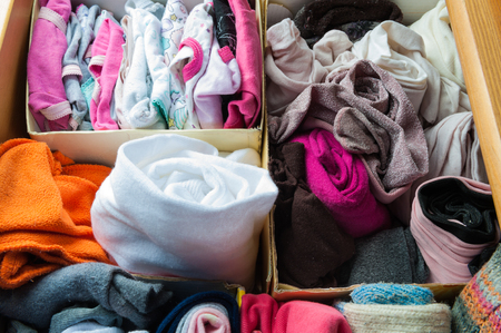 box with folded clothes divided into sectionsの写真素材