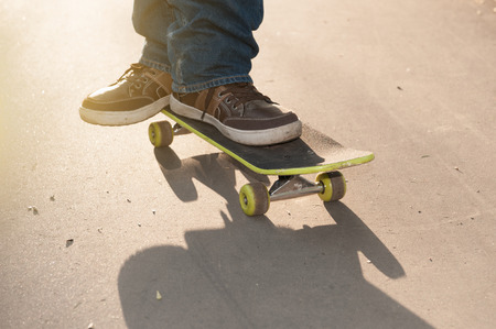 man in jeans and sneakers on a skateboard