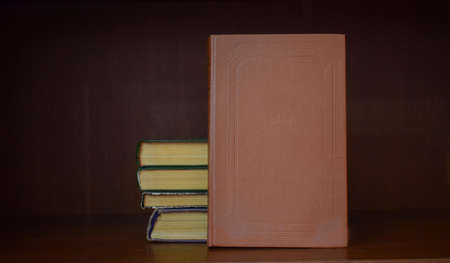 Books on a bookshelf with a blank cover for inscriptions.の写真素材