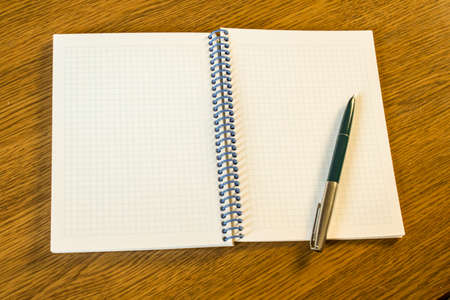 Open notebook and pen on the table. Space for inscriptions.の写真素材