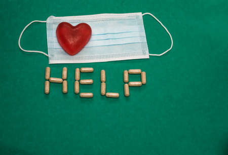 Medical mask heart and help inscriptionの写真素材