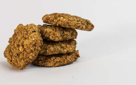 Cookies oatmeal nuts on a plate close-up on a white backgroundの写真素材