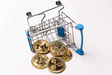 Coins of cryptocurrency bitcoin ripple monero fell from a supermarket trolleyの写真素材