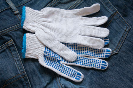 Work gloves white on a denim backgroundの写真素材