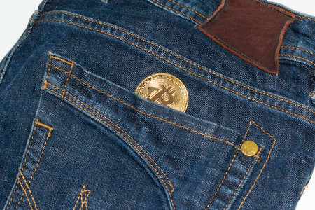 Bitcoin gold coin in jeans pocketの写真素材