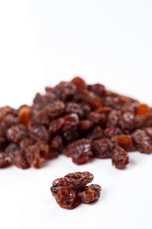 Heap of sultana raisins on white の写真素材