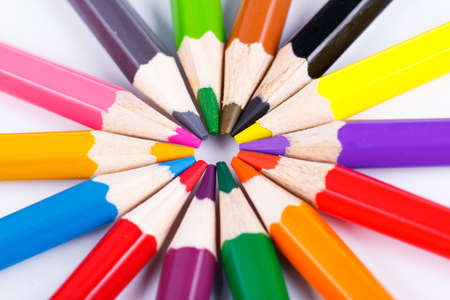 Colorful wooden pencils  in the circle isolated on white background