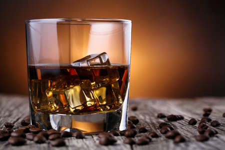 Alcohol on a wooden table with coffee beans.の写真素材