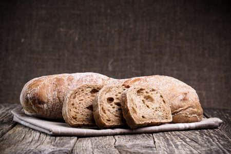 Slices of bread on a wooden background.