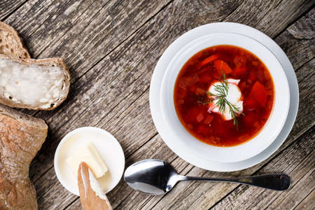 Borsch with bread on a wooden background.の写真素材