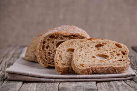 Slices of bread on a wooden background.