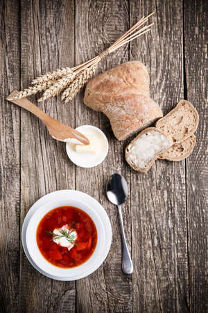 Borsch with bread on a wooden background.の写真素材