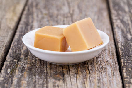 Delicious caramel candies on a white .の写真素材
