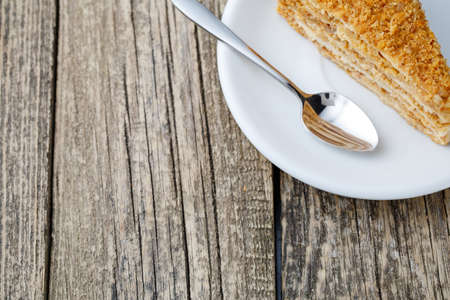 Delicious slice of honey cake on wooden background.の写真素材