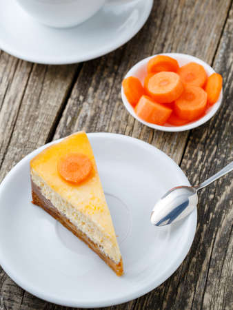 Slice of vegetarian carrot cake on white plate.の写真素材