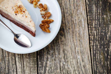 Delicious slice of nuts cake on wooden background.の写真素材
