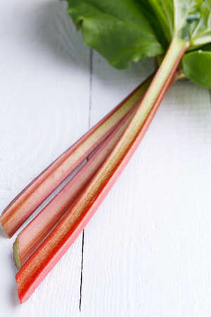 rhubarb on white wooden table.の写真素材