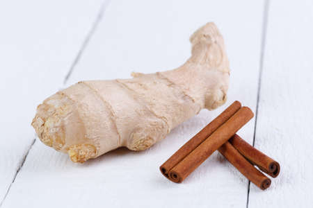 Fresh ginger on white wooden table.の写真素材