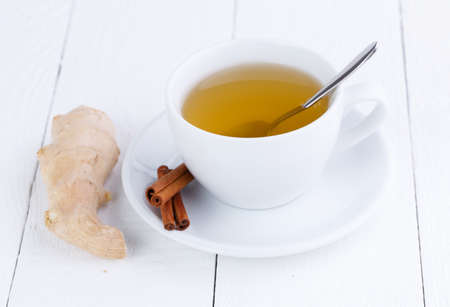 Fresh ginger on white wooden table.の写真素材