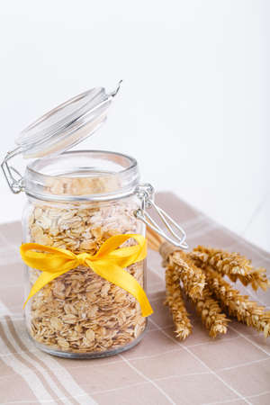 The oat flakes in glass jar and yellow ribbon.