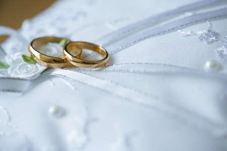 Gold wedding rings on the pincushion.の写真素材