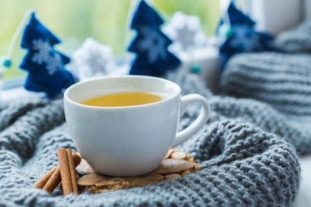 Cup of tea with scarf and Christmas toys.の写真素材