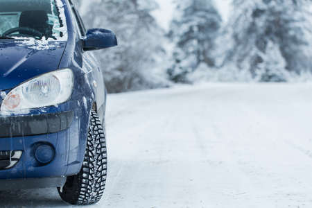 Blue car without a trade brand on winter road.