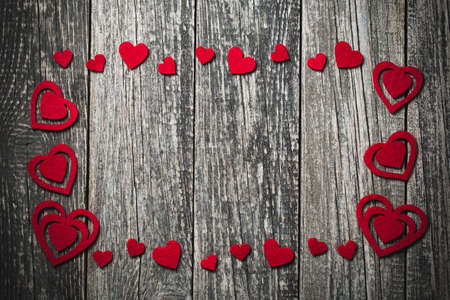 Wooden background with red hearts on Valentine's day.