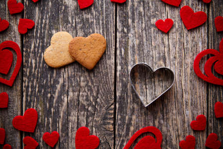 Heart shape ginger cookies on wooden table on valentine's day.