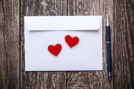 White envelope with red hearts for valentine's day.の写真素材