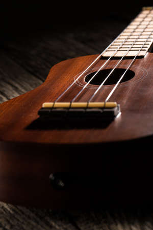 Close up of ukulele on old wood background.の写真素材